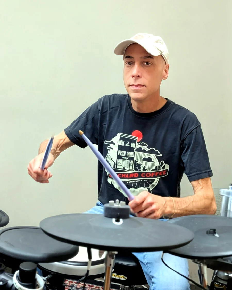 Studio owner playing electronic drums