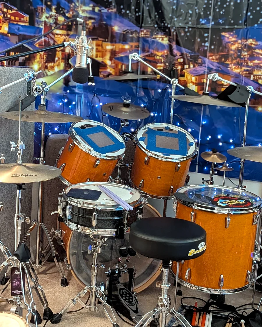 Acoustic drum kit, microphones, and percussion in the studio